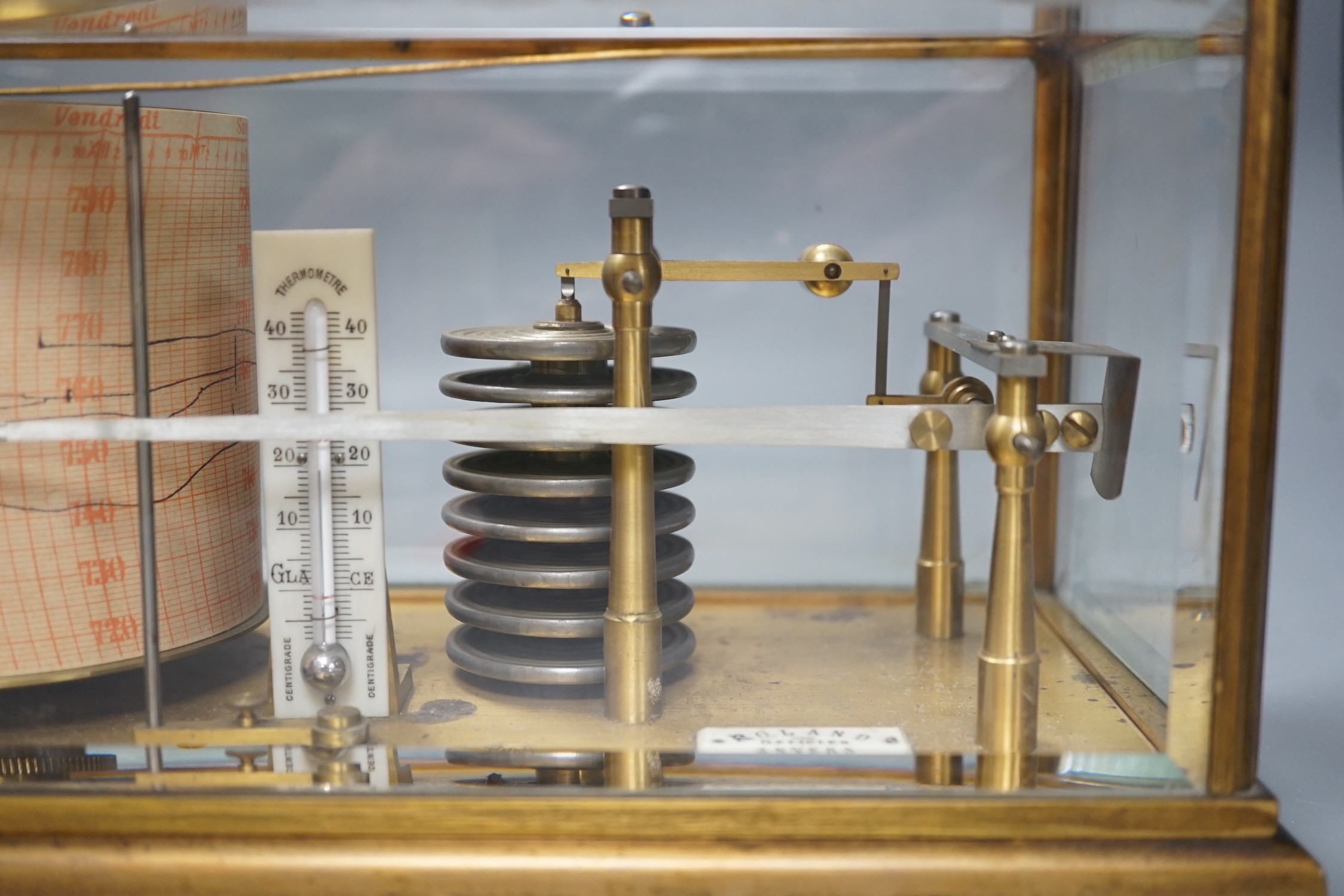 A French brass cased barograph, early 20th century, retailed by Roland, Anvers, number 65830, with ivory thermometer scale and retailers plaque, 30 cm wide